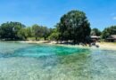 tropical beach with boats and crystal clear water