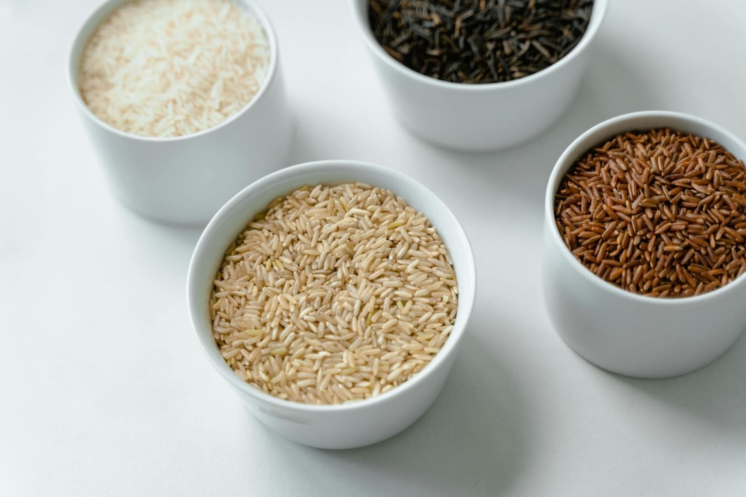 close up of variety of rice in bowls