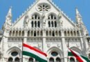 Hungarian parliament with flags of hungary in the front