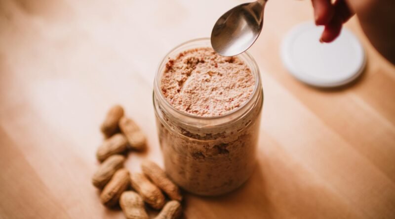 teaspoon over peanut butter in glass jar