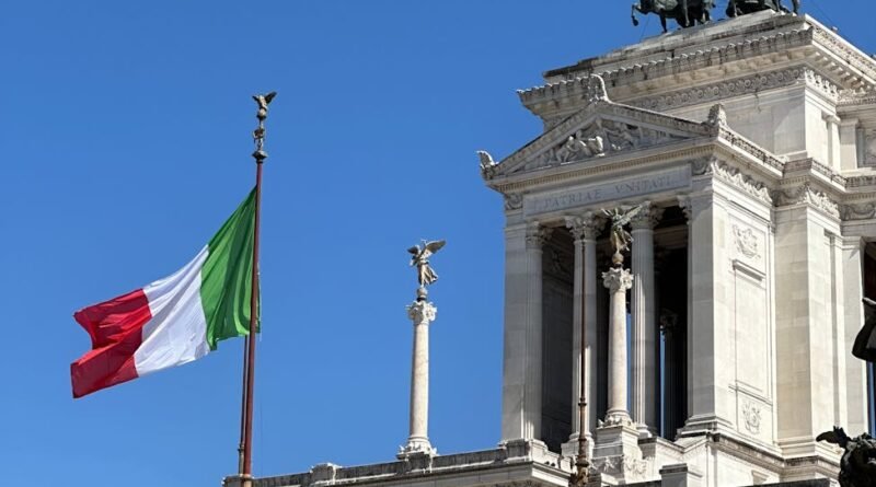 vittoriano monument in rome with italian flag