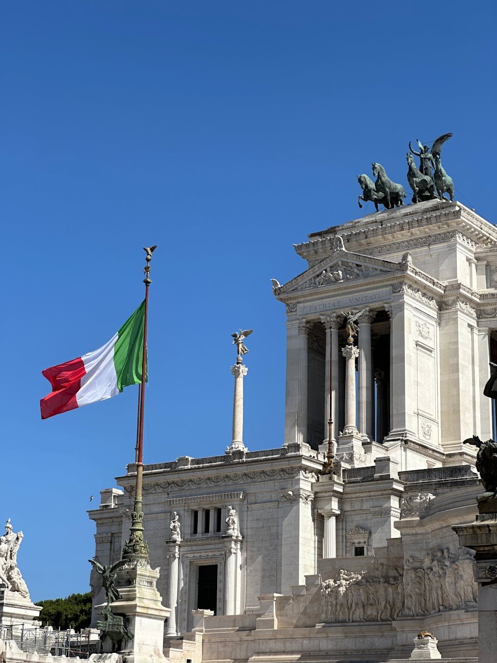 vittoriano monument in rome with italian flag