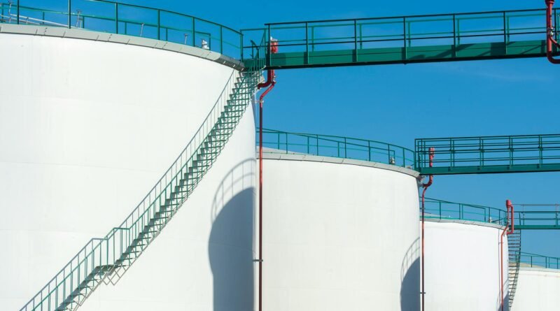 industrial storage tanks with walkway above