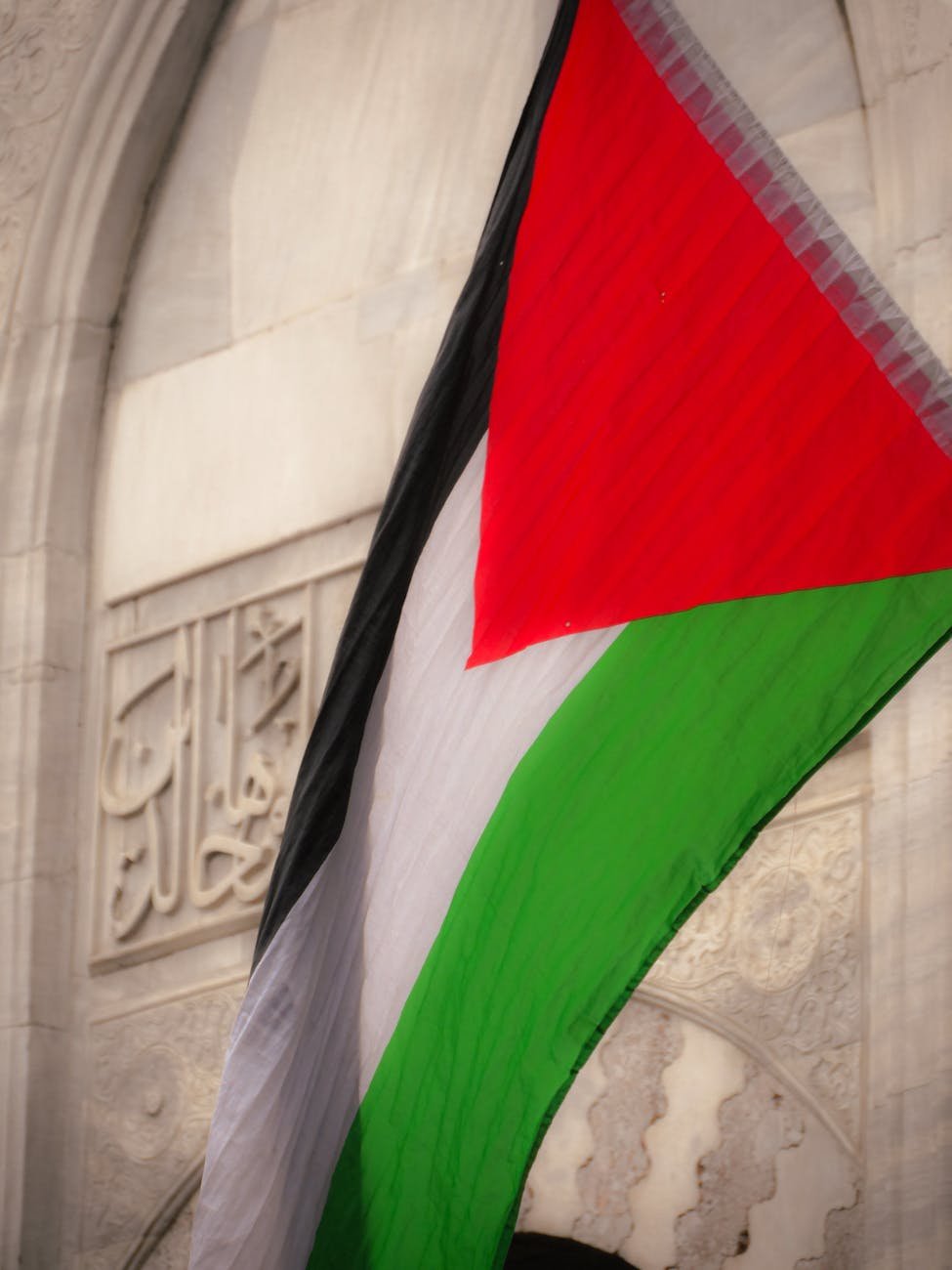 palestinian flag against historical architecture
