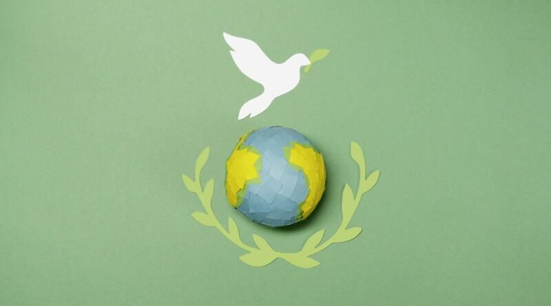 a globe and paper cutouts on a green surface