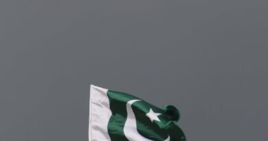 Market Bomb Blast in Northwest Pakistan Kills at Least Nine, Injures Dozens pakistani flag against stormy sky