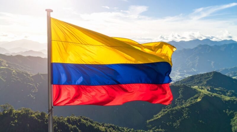 colombian flag flies over andean landscape