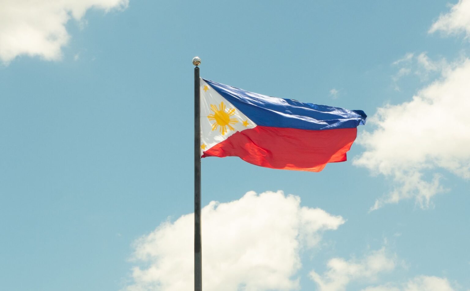 philippine flag against a bright blue sky