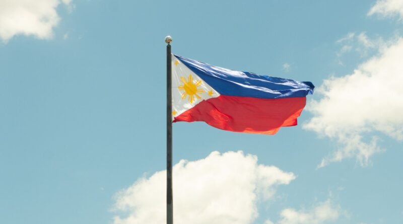 philippine flag against a bright blue sky