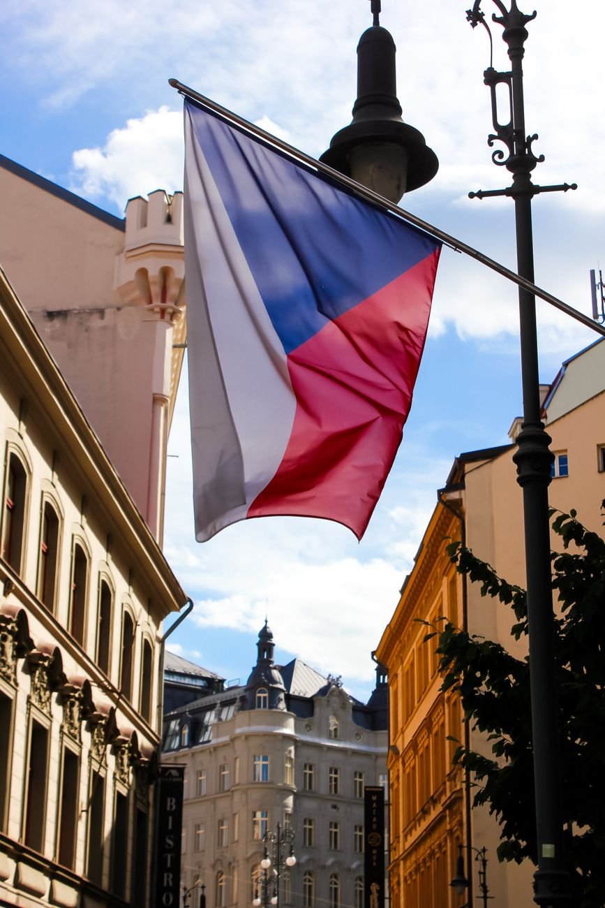czech flag waving in prague city street scene