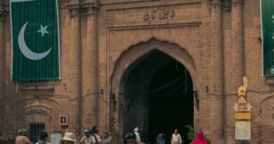 Roof Collapse at Pakistan Tuition Centre Kills 14 Children, Injures Dozens lahore fort entrance with national flags and visitors