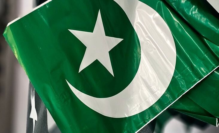 close up of pakistani flags with crescent and star