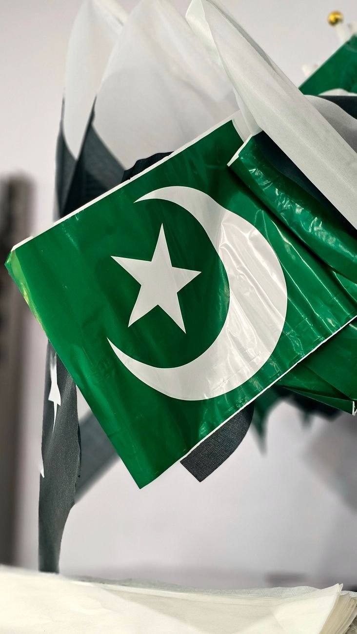 close up of pakistani flags with crescent and star