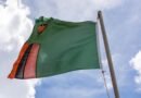 Zambia’s President Hakainde Hichilema Re-Elected for Second Term flag of zambia on wind