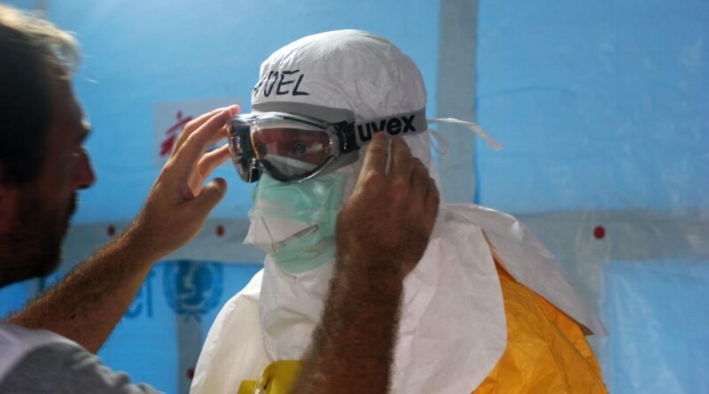 man wearing black goggles and protective suit